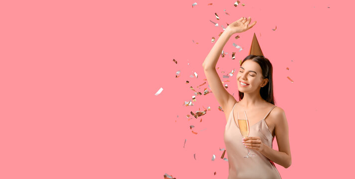 Beautiful Happy Woman With Glass Of Champagne And Falling Confetti On Pink Background With Space For Text