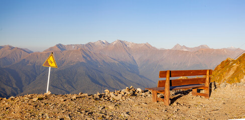 Wooden bench on the background of high mountains
