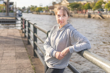 Mature woman posing on the river during a walk