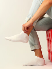 white sock with copy space on human foot close up photo on white background