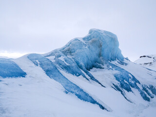 Picture of iceberg made of old blue ice and covered by fresh white snow, landscape photography of arctic circle. © Nostromo Trykowski