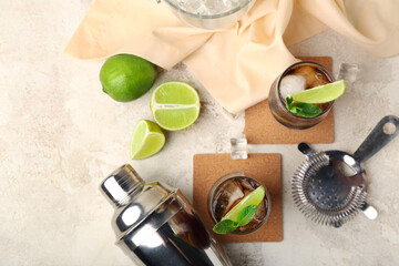 Glasses of cold Cuba Libre cocktail on light background