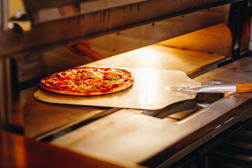 Taking pizza out the oven