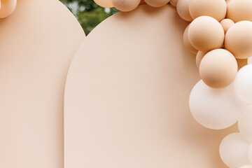 Party decoration with air balloons. Various balloons of different pastel colours and sizes.Creative gender neutral baby shower or birthday decoration, event in the garden. Festive photo zone arch kit.