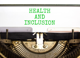 Health and inclusion symbol. Concept words Health and inclusion typed on beautiful retro old typewriter. Beautiful white background. Business motivational health and inclusion concept. Copy space.