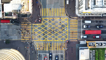 Car traffic transport on road, pedestrian people walk cross zebra crossing, crossroad junction in Mong Kok, Hong Kong downtown. Drone aerial top view. Asian lifestyle, Asia transportation city life - obrazy, fototapety, plakaty