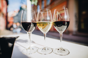Three glasses of  wine on a restaurant table outdoors