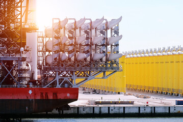 A set of blades loaded on the offshore construction vessel with brand new offshore wind monopile...