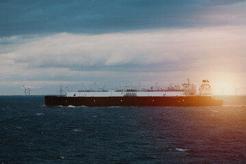 A very large gas carrier is underway with a wind park in the background. LNG tanker. Fully loaded...