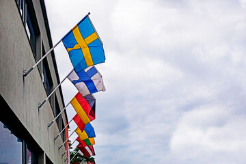 Europe, Estonia, Finland, Germany, Ukraine, Latvia, Lithuania flags on a building on a cloudy day