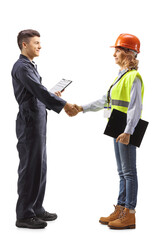 Full length profile shot of a worker shaking hand with a female engineer