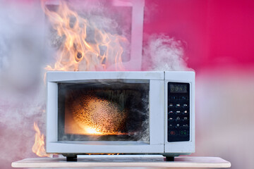 Home electrical fire with faulty household appliance, microwave oven ignited as result of short...