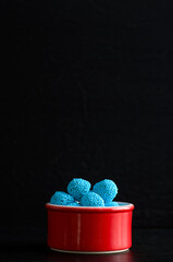 Macro Image of Blue Candies in a Red Bowl with Black Background