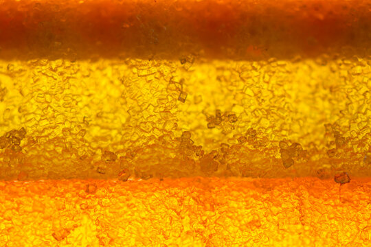 Texture of marmalade with sugar. Macro photo of marmalade, sugar crystals inside.
