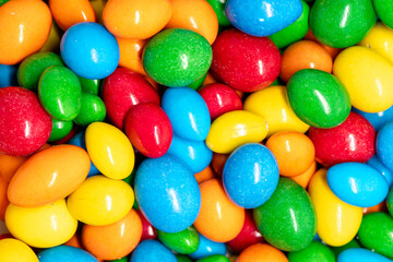 Fototapeta na wymiar Multi-colored bright candies on a white background. Peanuts in chocolate. Texture of colorful candies.
