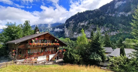 Gordijnen Switzerland travel . most scenic places. beautiful Lauterbrunnen village and valley surrounded by impressive Alps mountains with traditional wooden houses © Freesurf