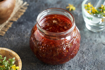 Macerating fresh St. John's wort flowers in oil to prepare a remedy