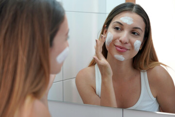 Skincare woman applying cream on her skin. Face moisturizing nourishing invigorating treatments....