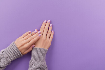 Womans hands with fashionable lavender manicure. Winter christmas nail design