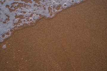 Waves on the beach of Trafalgar, Cádiz. Sand. Background.
