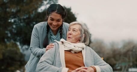 Senior woman, talking and outdoor with caregiver, nurse or healthcare service for person with a disability and wheelchair. Happy, face and elderly lady in park with care and support in retirement