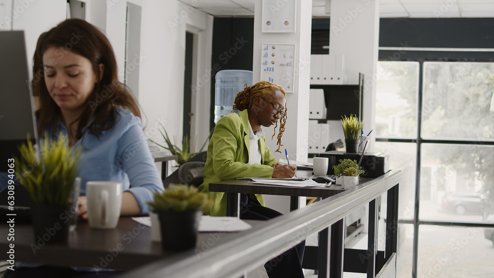 Aufkleber female assistant writing data on documents, taking notes on papers to create annual report. executiv