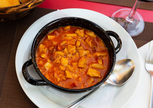 Traditional Spanish hearty and filling stew callos con garbanzos cooked with tripe, chickpea, chorizo and bacon seasoned with paprika in tomato sauce..