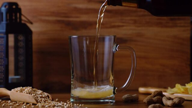 cold beer pouring to glass from bottle 4k footage, fresh summer beverage, pub and bar concept video