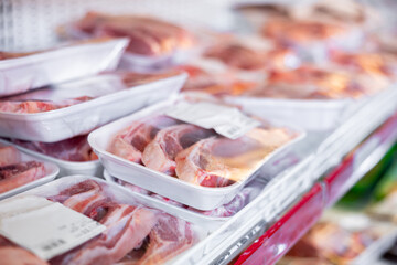 Pieces of fresh raw lamb packed in plastic trays wrapped in film with labels offered for sale in...