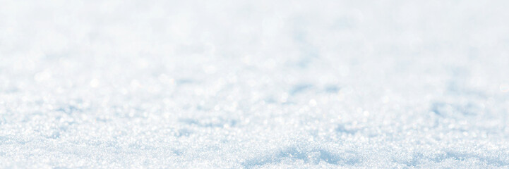 Snow surface close-up. Winter background with snow texture. Shallow depth of field and blur. Perfect for Christmas and New Year design. View with copy space.
