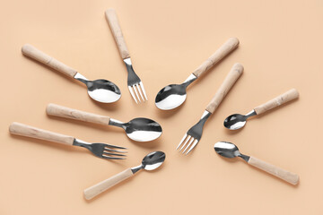 Silver cutlery on beige background