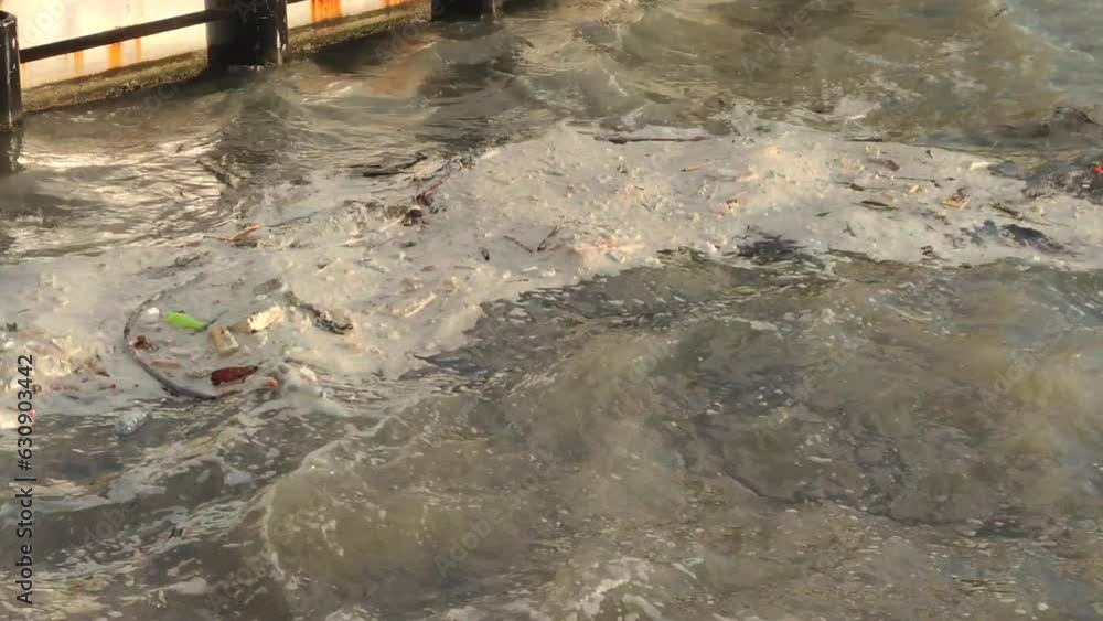 Poster garbage floats near seashore. environmental pollution.