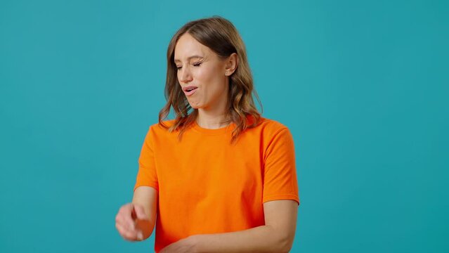 Woman grimaces with displeasure and makes facepalm gesture