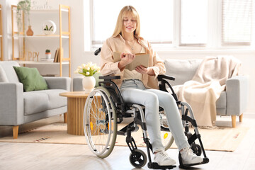 Young woman in wheelchair reading book at home
