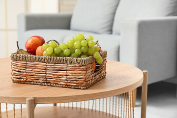 Wicker fruit basket on coffee table in living room, closeup