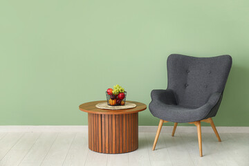 Fruit basket on table and armchair in living room