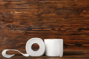 Rolls of toilet paper on wooden background
