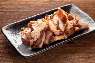 tasty slice fried pork in rectangular ceramic plate on rustic natural wood texture background