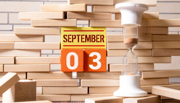 September 3.September 3 on wooden cubes on a white background.Autumn leave .Calendar for September.Autumn