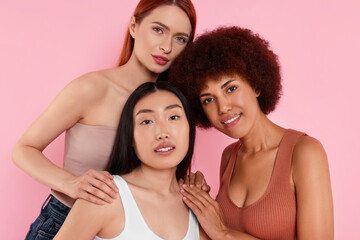 Portrait of beautiful young women on pink background