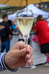 Tasting of sparkling white wine with bubbles champagne on summer festival route of champagne in Cote des Bar, Champagne region, France