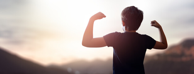 child with hands up in a beautiful sunset - concept of dreams and future education