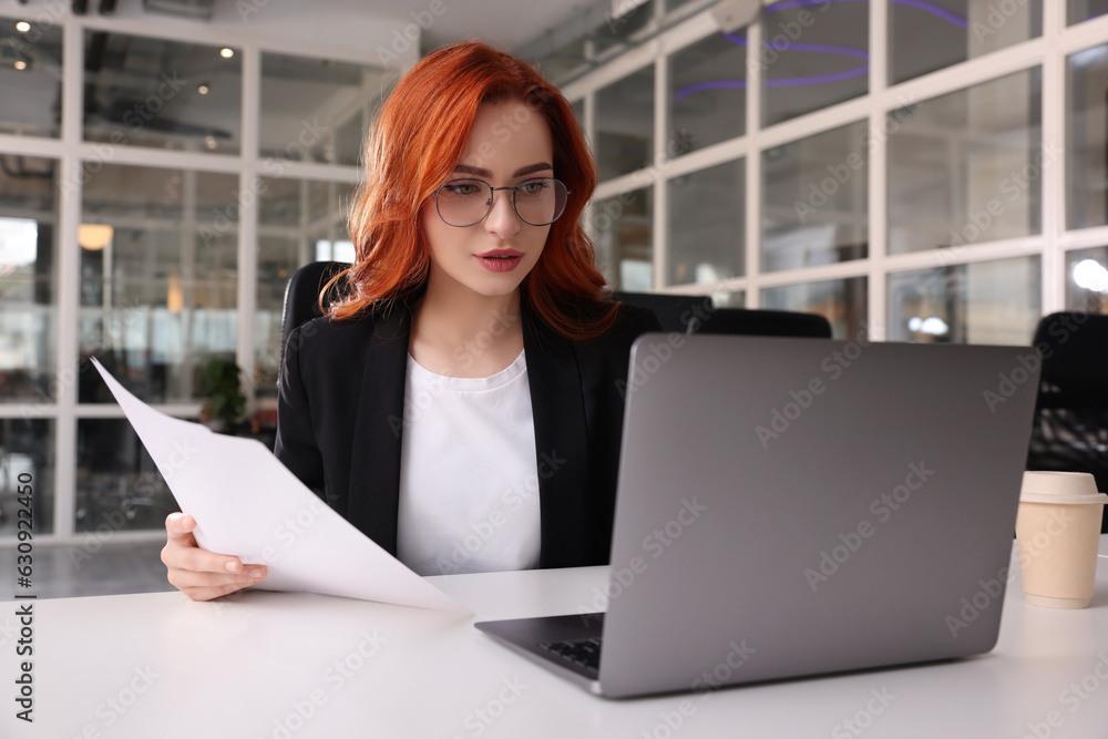 Sticker Woman with papers working on laptop at white desk in office