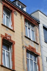 old town house in need of renovation with peeling paint and damage to the facade