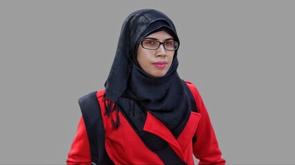 Close up portrait of young Muslim woman wearing black hijab and red jacket. Self confident and serious expression. 