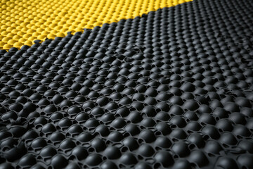 An up-close view of industrial safety mats made of durable rubber and featuring raised bumps for better grip and anti-slip protection