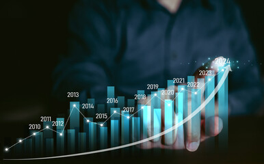 Concept business growing graph, chart with company progress and growth by year, 2024, economic growth, Business people check and analytic data of Annual Economic Growth Data. Digital screen touch.