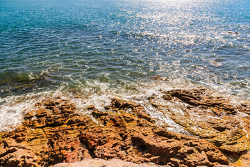 blue sea with rocks on the coast