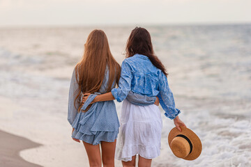 Beautiful mother and daughter at Carribean beach enjoying summer vacation