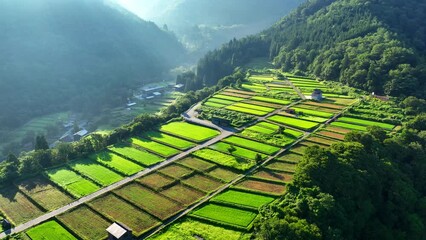 Sunrise over Terraced rice fields in the Japanese mountains, Shirakawago village in Japan, beautiful aerial view of Japanese Alps, tourism in Japan